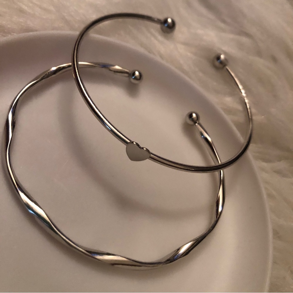 Two cuff bracelets, heart & twist